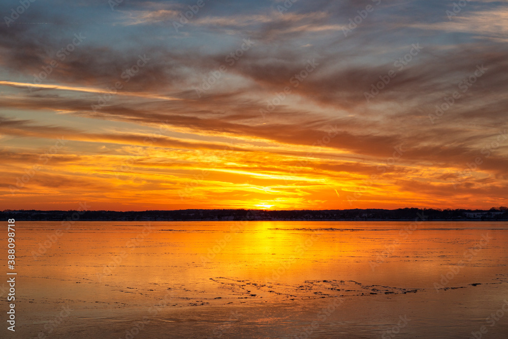 sunset over the ice on lake sunset over the ice on lake
