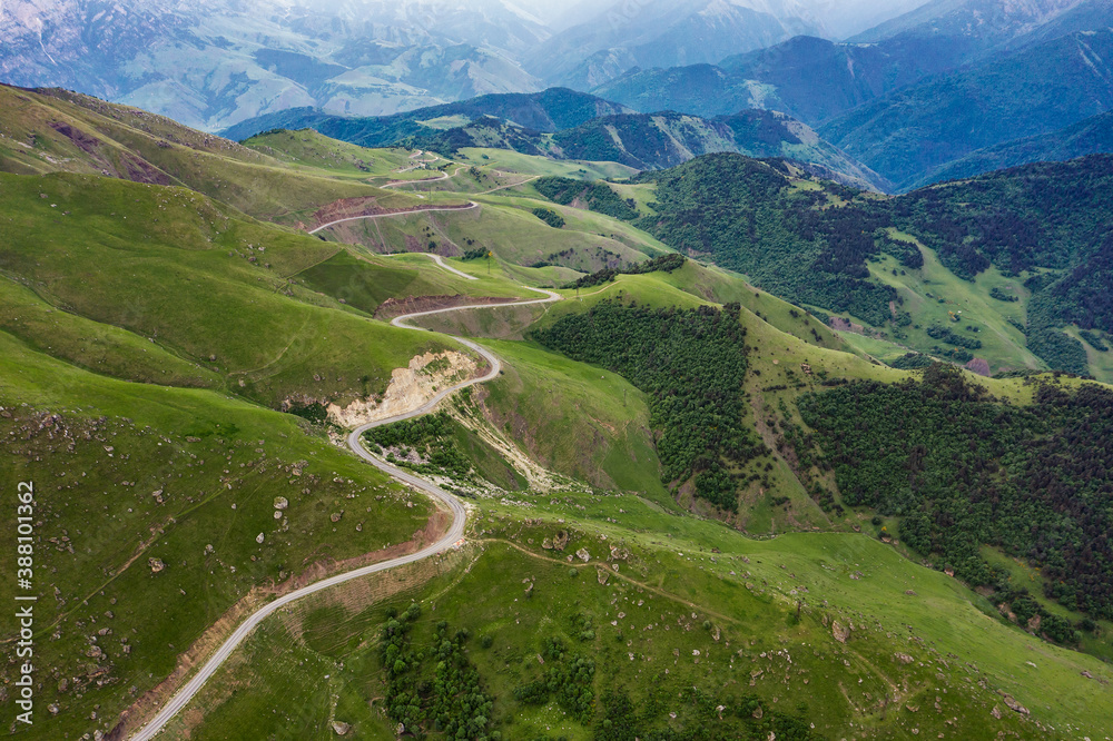Aerial view of road in Caucasus mountains, Road running through green hills