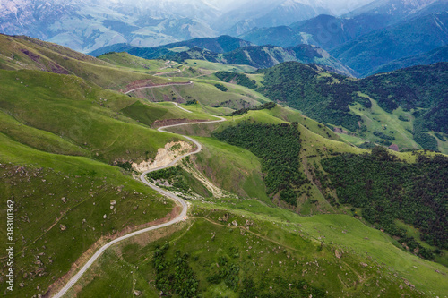 Aerial view of road in Caucasus mountains, Road running through green hills © Kokhanchikov