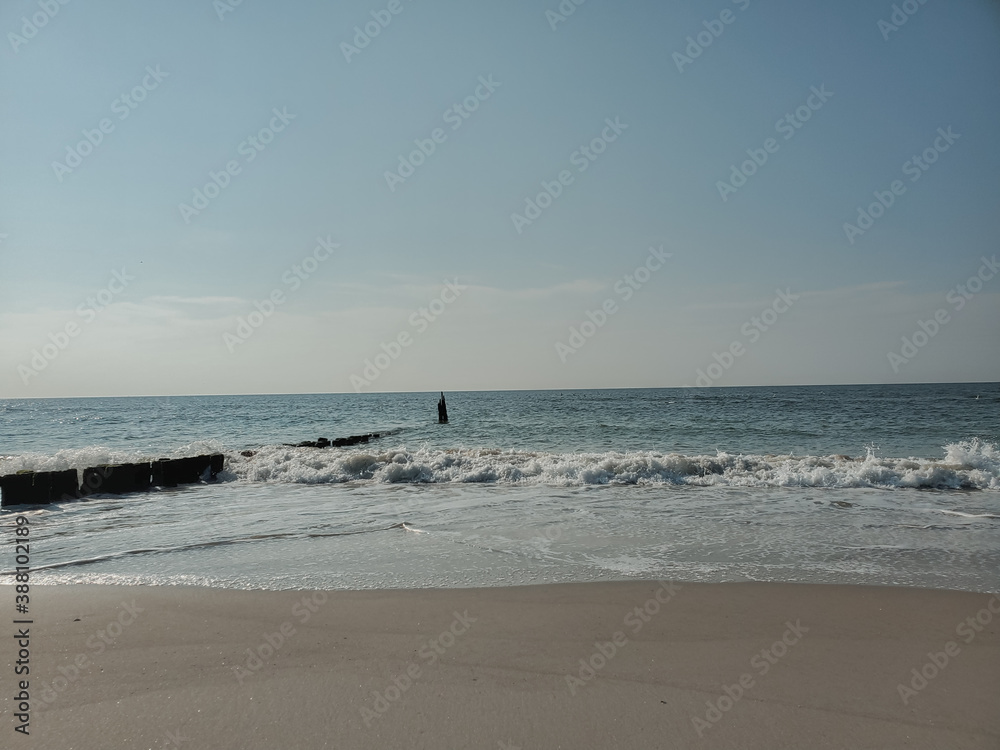City Beach, Rockaway beach, quiet and empty ocean with a peaceful glow in the background. New York City Beach, Rockaway beach, quiet and empty ocean with a peaceful glow in the background. New York
