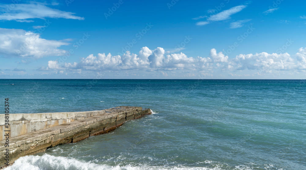 PARTENIT, CRIMEA - a landscape view of the sea with a breakwater, clouds. PARTENIT, CRIMEA - a landscape view of the sea with a breakwater, clouds.