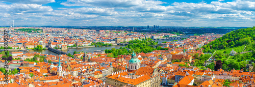 Panorama of Prague city. Aerial panoramic view of Prague Old Town historical centre, Charles Bridge Karluv Most across Vltava river and Mala Strana Town with red tiled roof buildings, Czech Republic