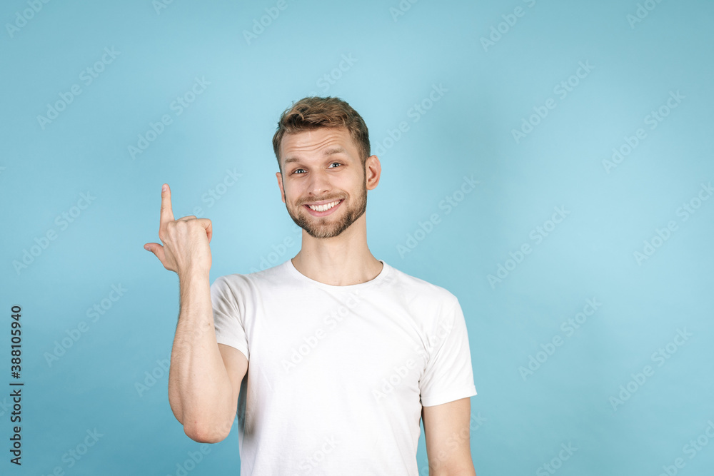 Happy adult guy pointing up with finger Happy adult guy pointing up with finger