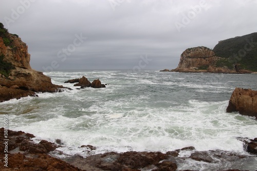 The Knysna Heads, sandstone cliffs that separate the Knysna Lagoon from the pacific ocean. A famous landmark along the renowned Garden Route, South Africa, Africa.