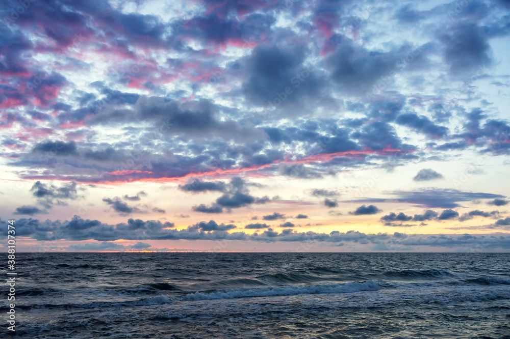 Sunset over the sea. Reflection of sunlight in the sea waves. The sky in the sunset rays. Russia Baltic Sea. Sunset over the sea. Reflection of sunlight in the sea waves. The sky in the sunset rays. Russia Baltic Sea.