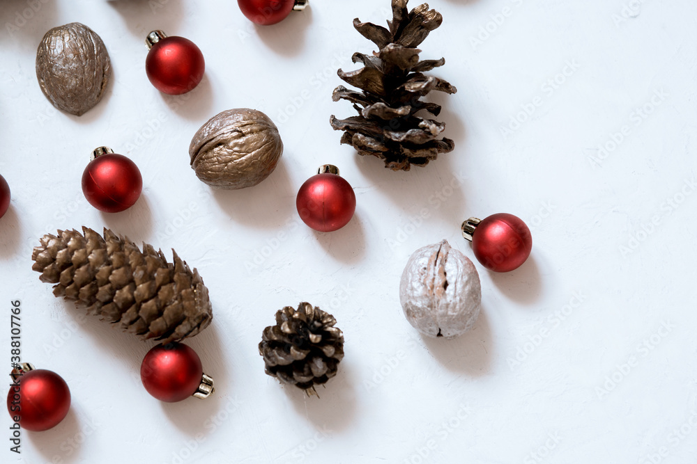 composition of cones, nuts, Christmas red balls on a white background Merry Christmas composition of cones, nuts, Christmas red balls on a white background Merry Christmas