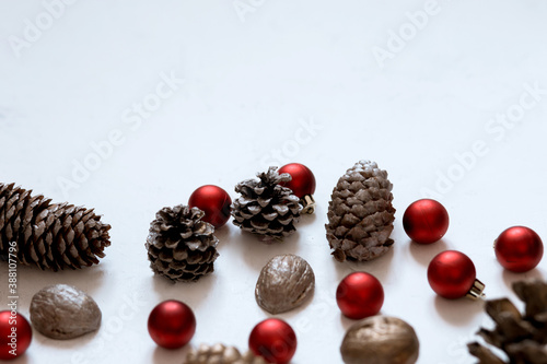 composition of cones, nuts, Christmas red balls on a white background Merry Christmas