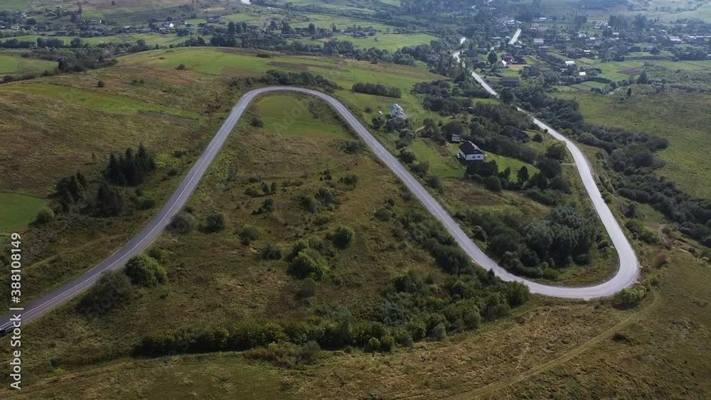 Aerial Drone Shot Of Winding Road By Mountain In Remote Ukraine. Aerial Drone Shot Of Winding Road By Mountain In Remote Ukraine.