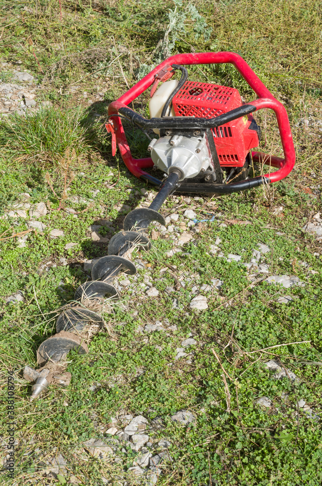 Gasoline Earth Auger on green grass Gasoline Earth Auger on green grass