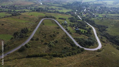 Aerial Drone Shot Of Winding Road By Mountain In Remote Ukraine.