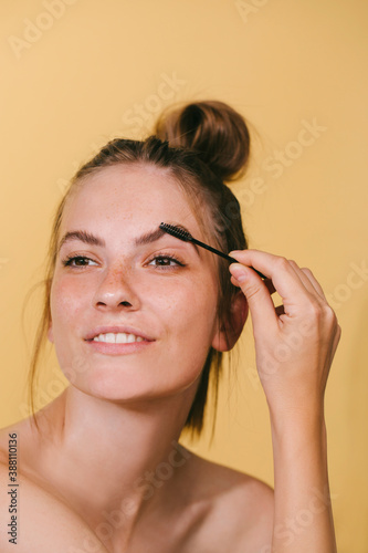 Woman Brushing Her Eyebrows