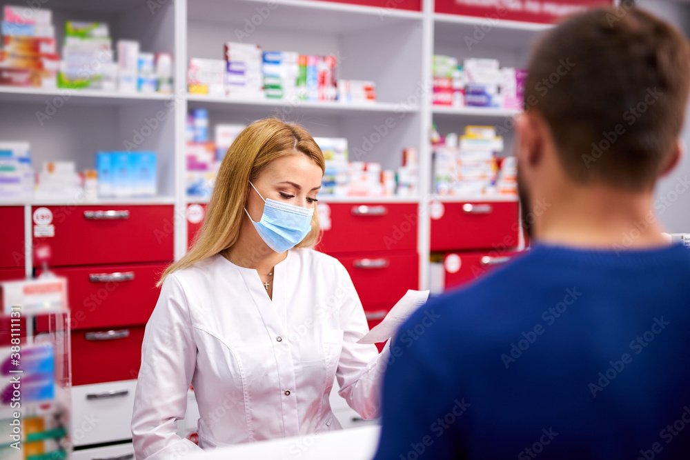 professional female pharmacist helping male customer choosing prescription drugs, consult sick clients. shopping at drugstore, taking advice from young chemist. Consumerism, friendly staff concept