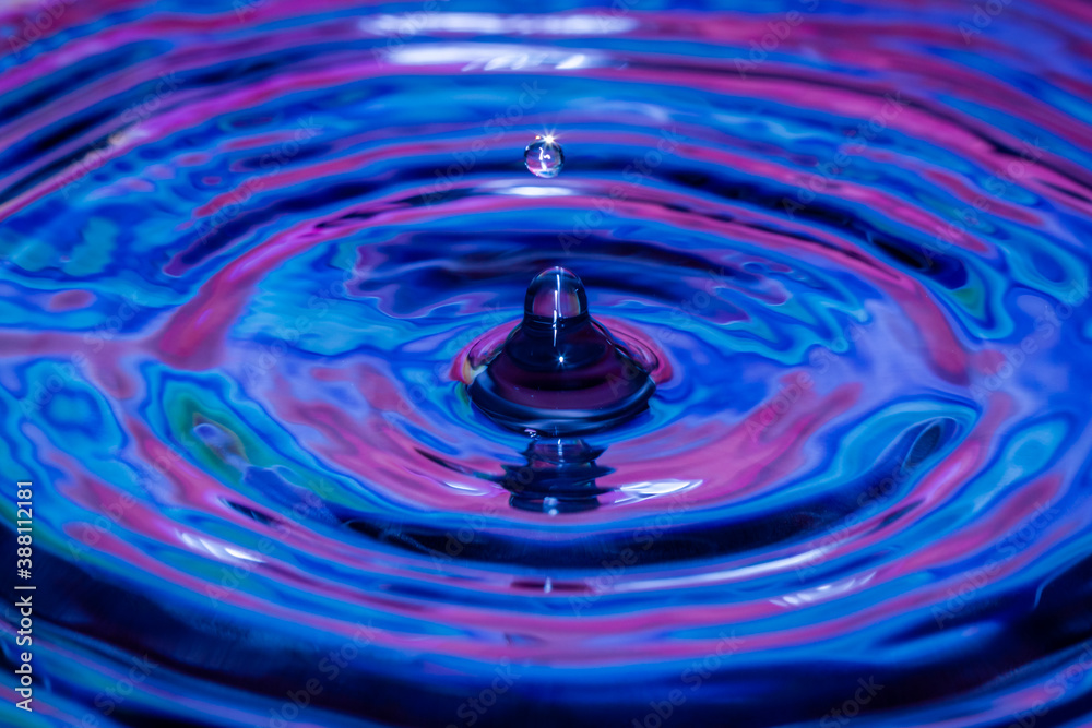 Water-drops, splash frozen in motion, blue and purple colours, with ripples and patterns Water-drops, splash frozen in motion, blue and purple colours, with ripples and patterns