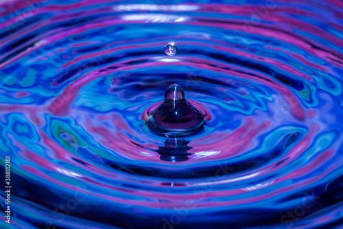 Water-drops, splash frozen in motion, blue and purple colours, with ripples and patterns 
