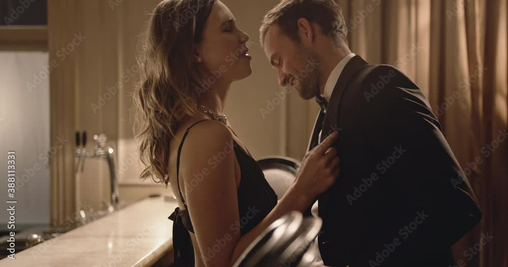 Beautiful young couple having fun at a gala party. Smiling young man and woman are enjoying dancing at a party.
