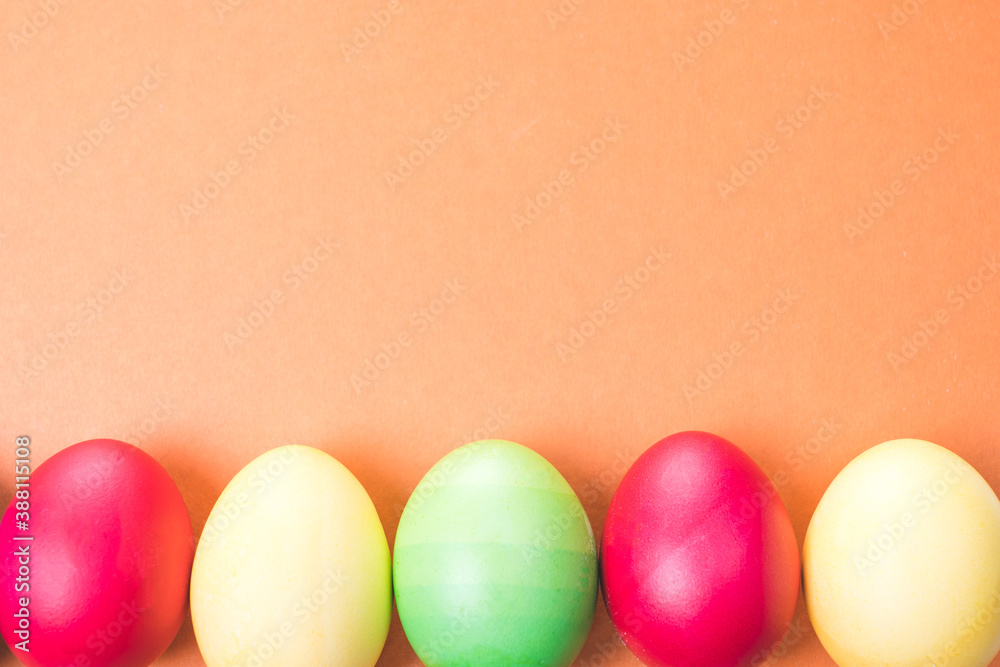 multicolored Easter eggs on a brown background, close-up