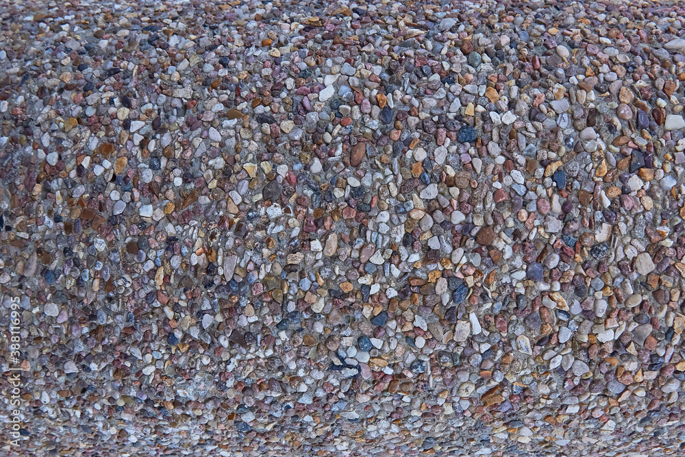 Fototapeta premium texture of stones in a light-colored concrete fence, crushed stone