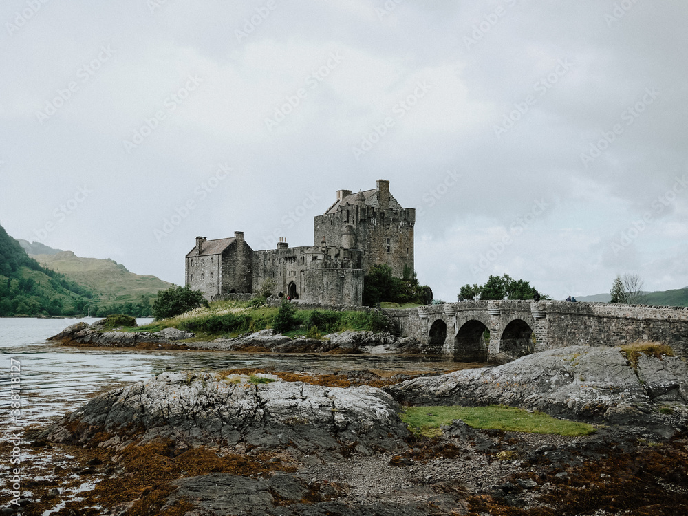 Old castle in Scotland sitting in the water with bridge