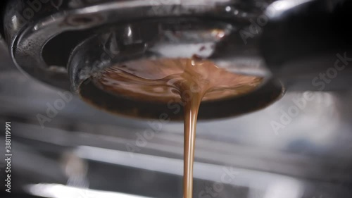 Perfect espresso pull. Creamy and perfectly pulled shot of espresso. Coffee shop artisan at work. Shot in 4k. 