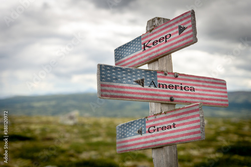 keep america great text on signpost with the american national flag.