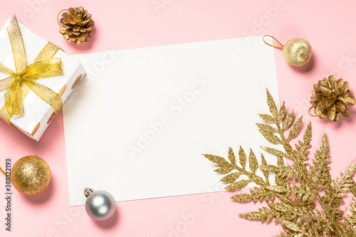 Christmas pink flat lay background with present box and decorations.