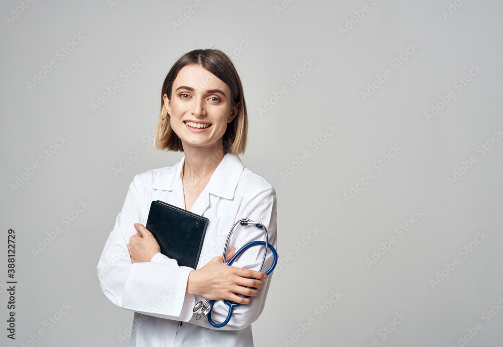 woman doctor with stethoscope and medical gown documents in hands woman doctor with stethoscope and medical gown documents in hands
