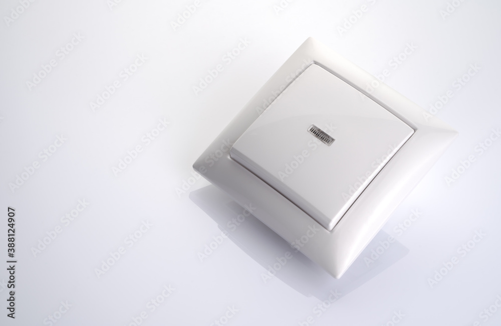 New light switch glossy background. Side view. The concept of electrics. New light switch glossy background. Side view. The concept of electrics.