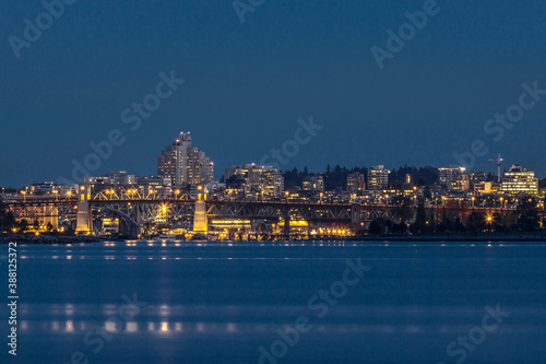 Yaletown and Burrard Bridge in False Creek at night time on the background of Granville Island and Vancouver City