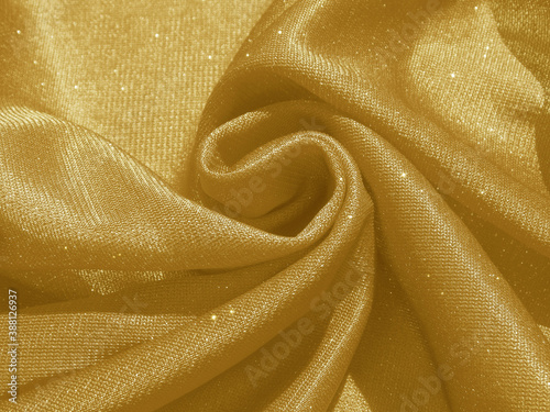 Shiny gold crumpled fabric. Elegant cloth background