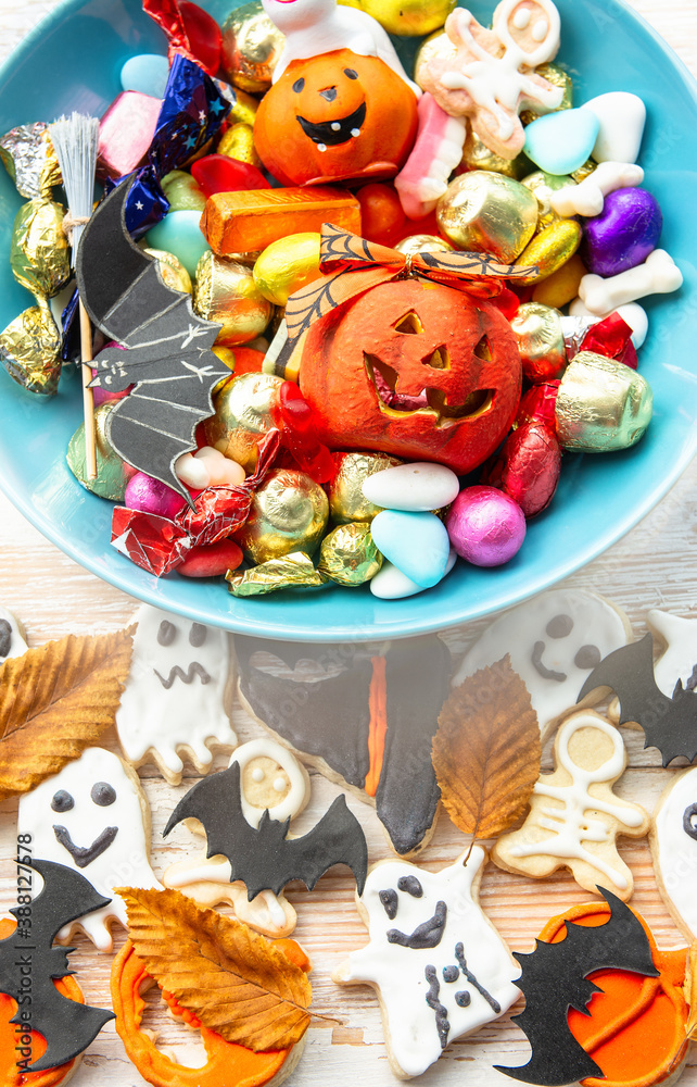 candy bowl of chocolates and sweets, Halloween Jack o Lantern cookies - Trick or Treat Halloween card background candy bowl of chocolates and sweets, Halloween Jack o Lantern cookies - Trick or Treat Halloween card background