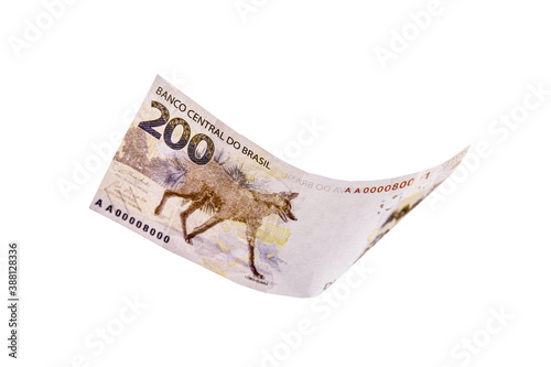 two hundred reais banknote, in free fall, money rain with white background. One-off focus, concept of inflation, loss, devaluation photo