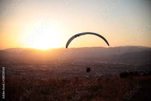 paraglider silhouette on sunset