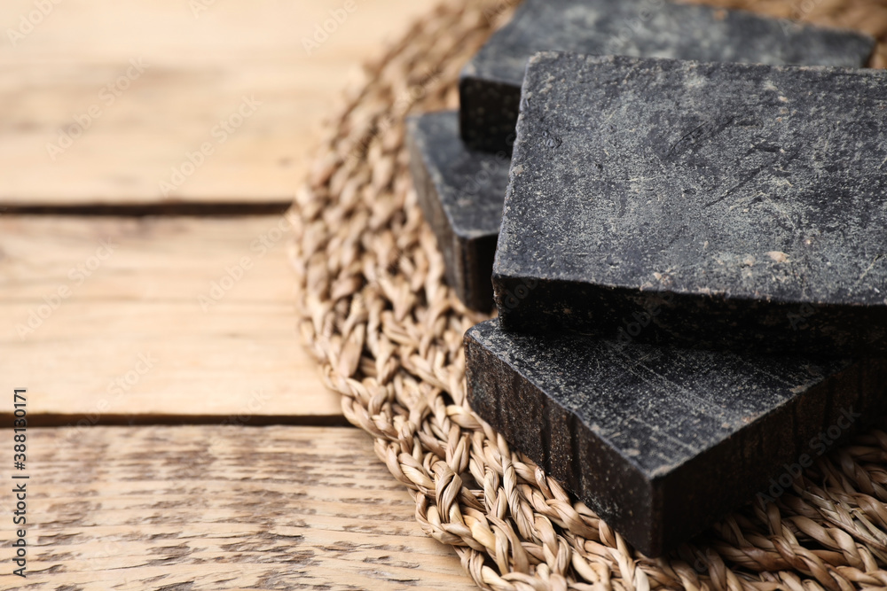 Natural tar soap on wooden table, closeup Natural tar soap on wooden table, closeup