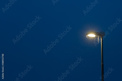 Street lamp covered in snow and icicle