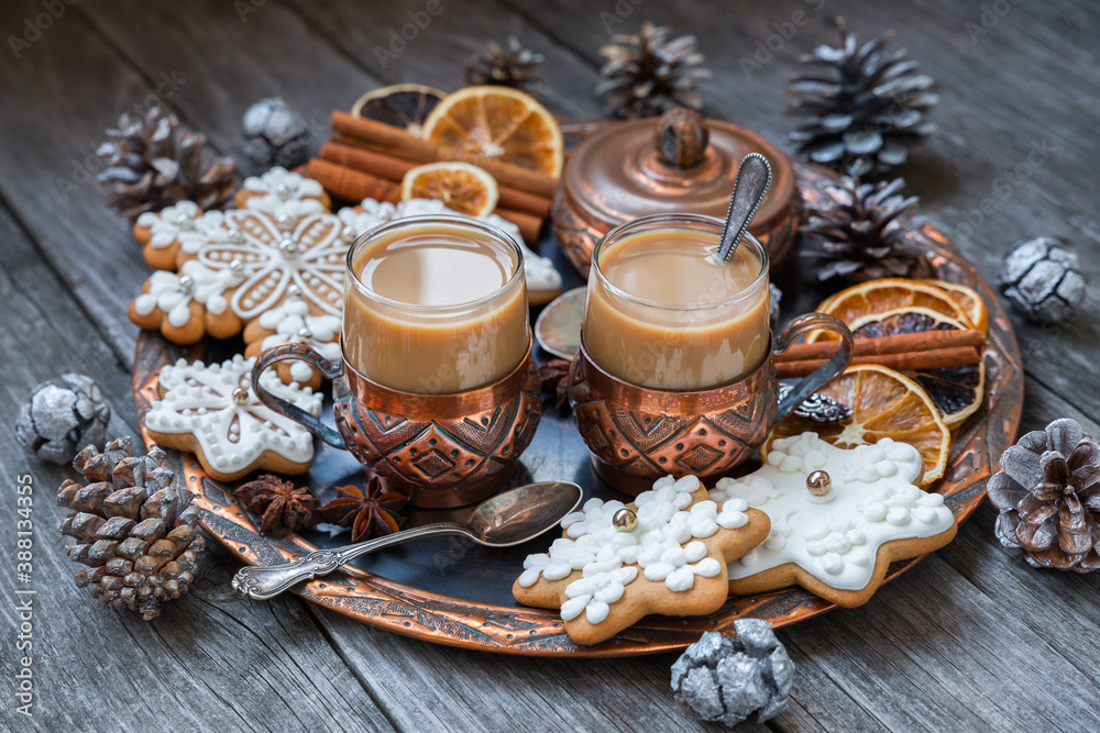 Copper cups of hot coffee with cream, cinnamon, anise and gingerbread on a copper tray. Christmas food concept in vintage style. Copper cups of hot coffee with cream, cinnamon, anise and gingerbread on a copper tray. Christmas food concept in vintage style.