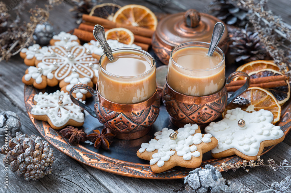 Copper cups of hot coffee with cream, cinnamon, anise and gingerbread on a copper tray. Christmas food concept in vintage style. Copper cups of hot coffee with cream, cinnamon, anise and gingerbread on a copper tray. Christmas food concept in vintage style.