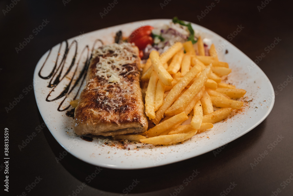 roast meat with cheese and salad on a plate and salad on a plate roast meat with cheese and salad on a plate and salad on a plate