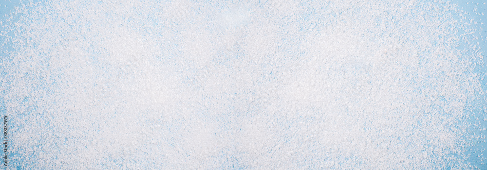 Christmas background texture, white snow on a blue background. Banner as a backdrop, an idea. View from above