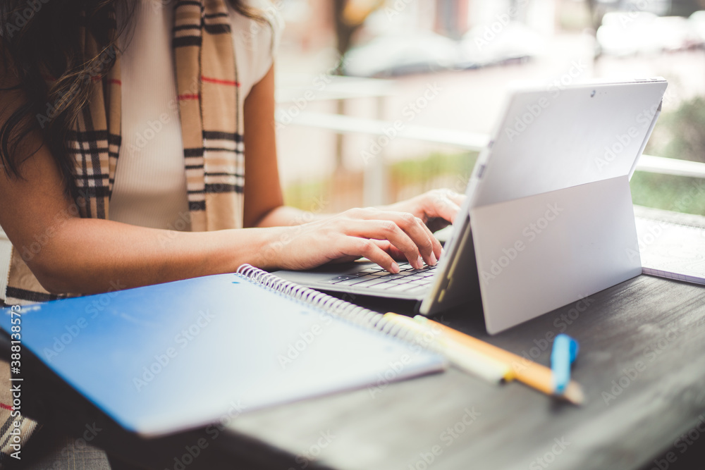 Fototapeta premium young person working on laptop outdoors on a patio