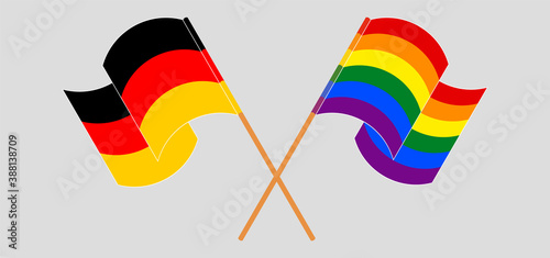 Crossed and waving flags of Germany and LGBTQ