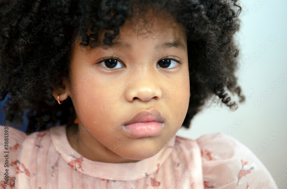 Portrait of little african american girl begging eyes. Black kid girl