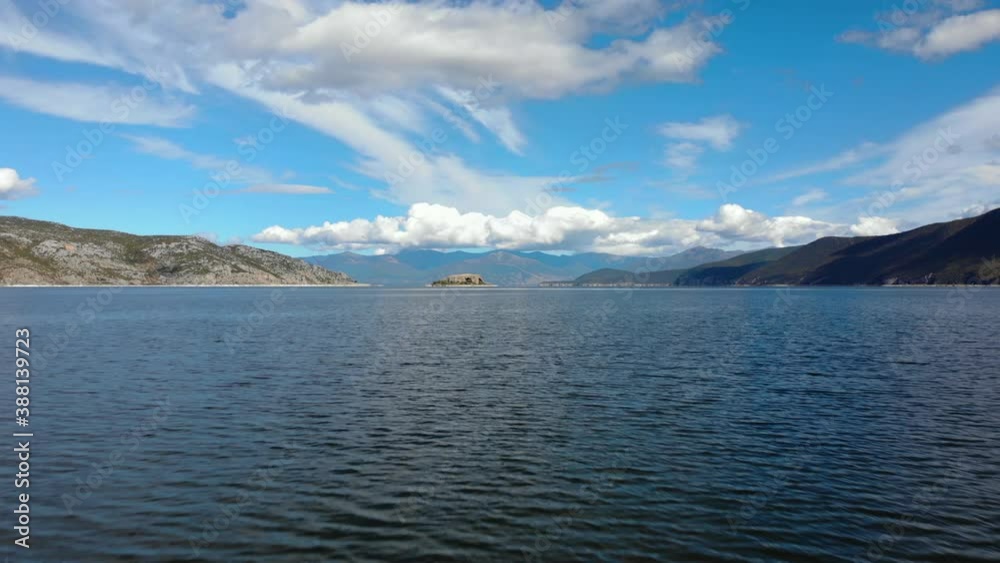 Vibrant water surface of Prespa lake and mountains background at a cloudy day Vibrant water surface of Prespa lake and mountains background at a cloudy day