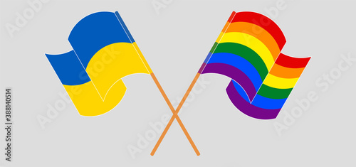 Crossed and waving flags of LGBTQ and the Ukraine
