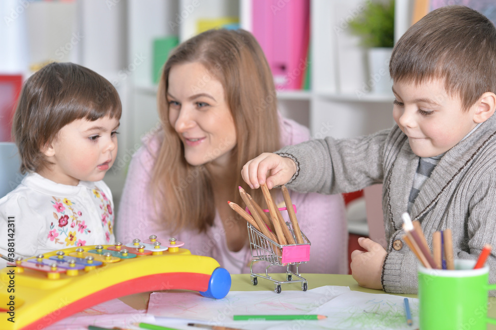 Mother with children playing together at home Mother with children playing together at home