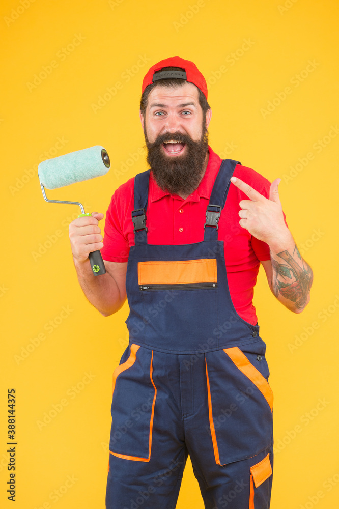 foreman going to make wall facing. happy brutal man in boilersuit uniform. mature hipster use paint roller tool for painting. repairman or builder working. creative idea foreman going to make wall facing. happy brutal man in boilersuit uniform. mature hipster use paint roller tool for painting. repairman or builder working. creative idea