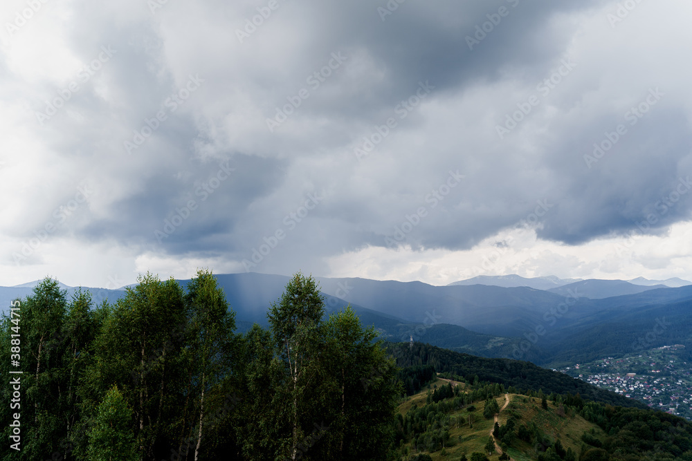 Rainfall in Karpathians mountains. Landscape of a beautiful countryside without people. Panoramic view in summer time. Advert for travel agency