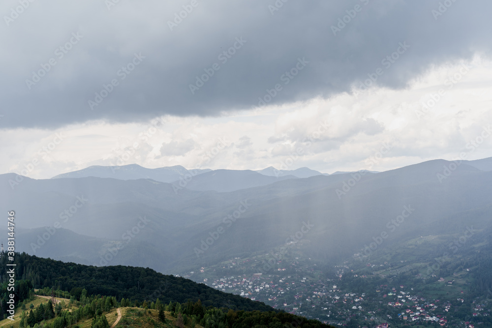 Rainfall in Karpathians mountains. Landscape of a beautiful countryside without people. Panoramic view in summer time. Advert for travel agency