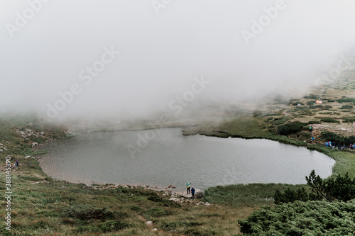 Mountain lake and in foggy day. Fog in Karpathian mountains. Tourism in Ukraine. Freedom and unity with nature