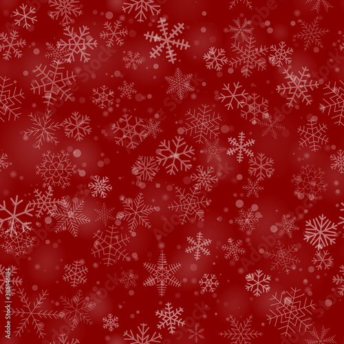 Christmas seamless pattern of snowflakes of different shapes, sizes and transparency, on red background
