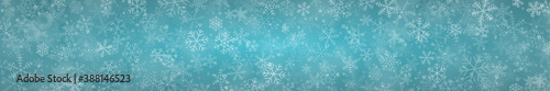 Christmas banner of snowflakes of different shapes, sizes and transparency on light blue background